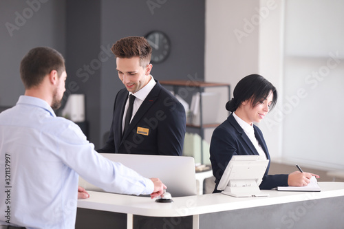 Fotografía Receptionists working with visitor in office