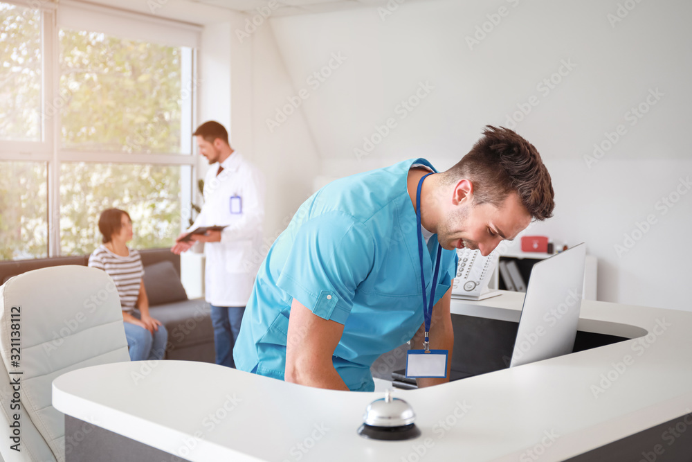 Male receptionist working in clinic