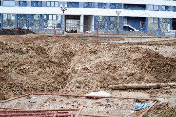 Construction of a large multi-storey comfortable concrete cement modern new monolithic-frame multi-storey building with windows, walls and balconies