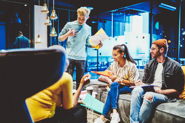 Canvas Print - Cheerful successful multiracial group of colleagues discussing business project in office