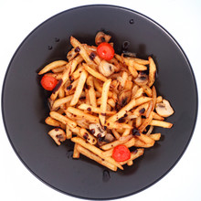 French Fries With Tomatoes And Mushrooms On A Black Plate. White Background.