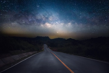 Wall Mural - road and milky way with mountain at night.