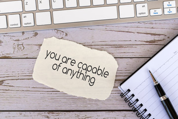 Wall Mural - You are capable of anything inspirational quotes on torn paper on top of wood background