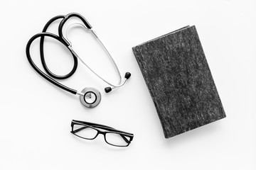 Wall Mural - Medical books near stethoscope on white background top-down