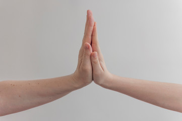 Wall Mural - child making hi five gesture over white wall background