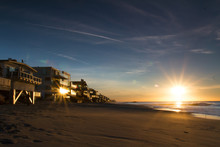 Sunrise At Beach With Oceanfront Homes In Malibu, California