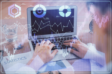 Multi exposure of forex graph with man working on computer on background. Concept of market analysis.