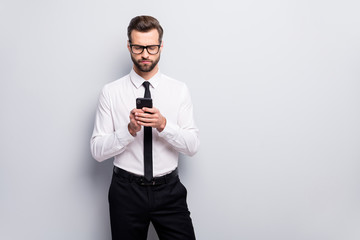 Photo of handsome young macho business man holding telephone reading partners email wear specs white office shirt black tie trousers isolated grey color background