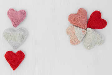 Wall Mural - Hand made knitted heart on white wooden background. Valentine's day card with woolen heart and free space. Romantic sign.Hand made knitted heart on white wooden background. Valentine's day card with w