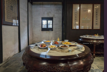 Food on a round table at a restaurant in shen hall, zhouzhuang ancient town, China