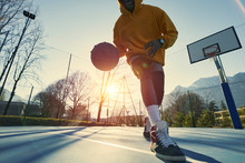 Athletic Black Man Showing His Backetball Skills On Court Outdoors.