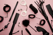© LIGHTFIELD STUDIOS - top view of black sex toys on pink background