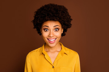 Poster - Closeup photo of beautiful pretty dark skin curly lady open mouth cheerful facial expression listen amazing good news wear yellow shirt isolated brown color background