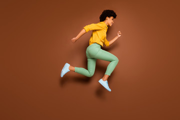 Canvas Print - Full length photo of funny dark skin lady jumping up high rushing discount shopping center black friday wear yellow shirt green pants footwear isolated brown color background