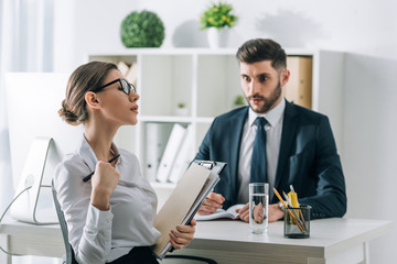 Wall Mural - selective focus of secretary seducing shocked businessman in office