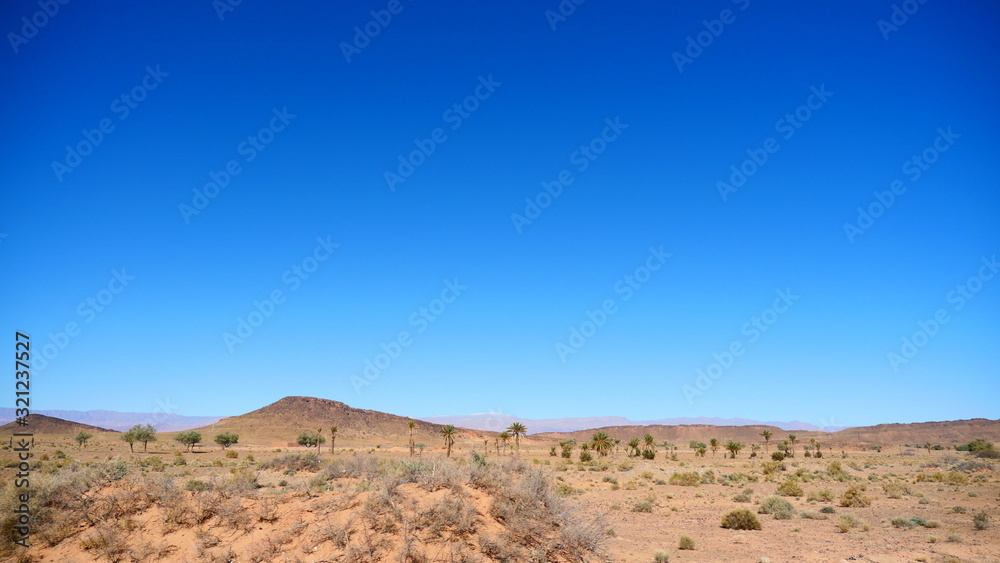 Bright landscape of Morocco, breathtaking curves of mountains, stunning combination of hills & farm land,inadvertent distribution of houses & huts, raw impression of pure nature.