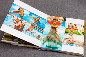 Wall Mural - Photobook album on deck table with travel photos