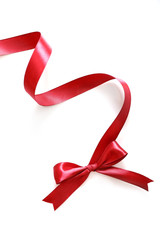 Shiny red satin ribbon and bow isolated on white background