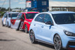 © tsuguliev - View of autodrome race circuit racetrack with a line of cars driving and racing, with audience and during rally autocross racing competition
