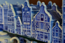 Delft, The Netherlands, August 2019. At A Shop Of The Famous Blue And White Ceramics The Typical Dutch Miniature Houses To Buy As Souvenirs.