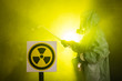 © satura_ - Radiation, pollution and danger concept - Man in protective clothing and a gas mask on a dark background