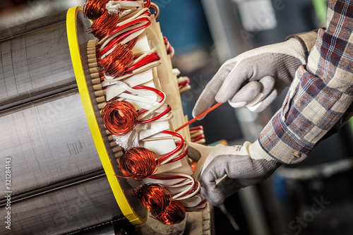 Cuadros en Lienzo Skilled industrial worker assembling a large electric motor