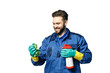 © Eno1 - Young handsome man with a beard in the uniform of a cleaner smiles while holding a rag and chemical spray bottle. Wipe invisible glass on a white background.