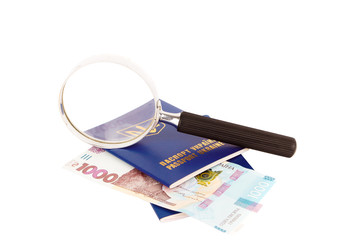 Two Ukrainian passports, loupe and one thousand hryvnias, isolated