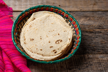 Mexican corn tortillas on wooden background