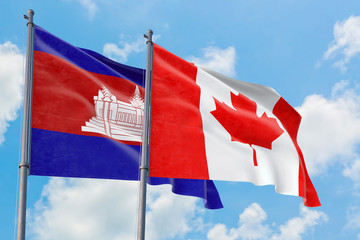 Wall Mural - Canada and Cambodia flags waving in the wind against white cloudy blue sky together. Diplomacy concept, international relations.