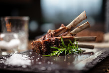 Grilled Lamb Chops Served With A Branch Of Rosemary