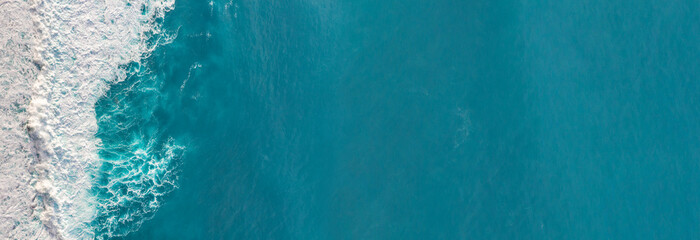 Wall Mural - aerial view to waves in ocean splashing waves.