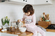 © laniko - Toddler girl having granola breakfast