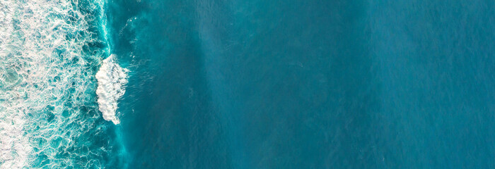 Wall Mural - aerial view to waves in ocean splashing waves.