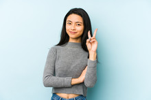 Young Chinese Woman Isolated On A Blue Background Showing Number Two With Fingers.