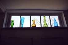 Vintage Colored Glass Vases In A Row On A Window Sill