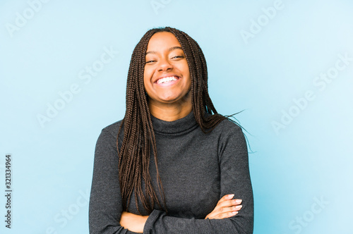 Fotografía Young african american woman isolated on blue background laughing and having fun