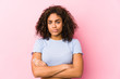 © Asier - Young african american woman against a pink background frowning face in displeasure, keeps arms folded.