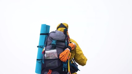 Wall Mural - vr virtual reality headset. young man hiker moving hands on cloudy sky and fog background. yellow ho