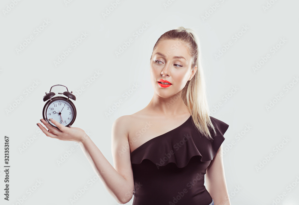 Time is ticking. Young smiling woman with alarm clock isolated white ...