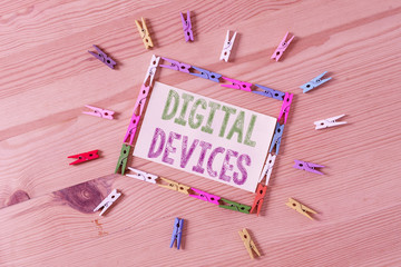 Poster - Word writing text Digital Devices. Business photo showcasing physical unit of equipment that contains a microcontroller Colored clothespin papers empty reminder wooden floor background office