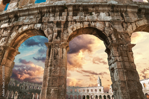 Fotomural View on church bell tower through amphitheater arches