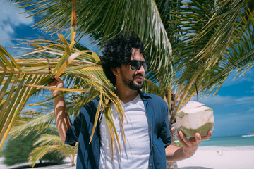 Handsome man on vacation on a tropical shore.