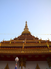 Wat Nong Wang in Khon Kaen Essan Thailand a temple with 9 golden levels and Payanak surrounding the exterior