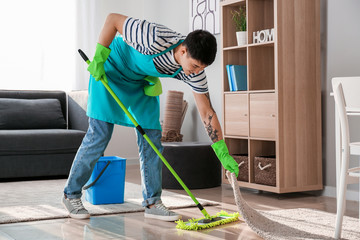 Sticker - Young Asian man cleaning floor at home