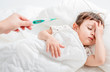 © Tom Wang - Sick child with flu fever laying in bed and mother holding thermometer