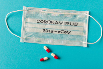 Coronavirus. The inscription coronavirus on the protective medical mask. On blue background. The concept of protection from viruses.