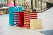 colorful shopping bags is on the floor in the luxury mall close up