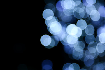 Wall Mural - background with blurred blue circles of lights. defocused lights of festive garland