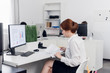 © Anna Kosolapova - Red hair woman sits at a table and works with documents in the office